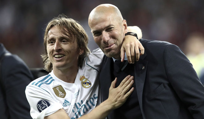 Real Madrid's French coach Zinedine Zidane (R) and Real Madrid's Croatian midfielder Luka Modric celebrate after winning the UEFA Champions League final football match between Liverpool and Real Madrid at the Olympic Stadium in Kiev, Ukraine on May 26, 2018. (Photo by Isabella BONOTTO / Update Images Press / AFP) (Photo credit should read ISABELLA BONOTTO/AFP/Getty Images)