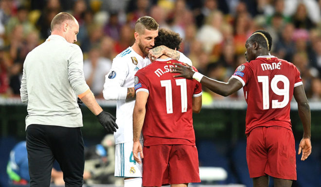 KIEV, UKRAINE - MAY 26: Sergio Ramos of Real Madrid consoles Mohamed Salah of Liverpool as he leaves the pitch injured during the UEFA Champions League Final between Real Madrid and Liverpool at NSC Olimpiyskiy Stadium on May 26, 2018 in Kiev, Ukraine. (Photo by Michael Regan/Getty Images)