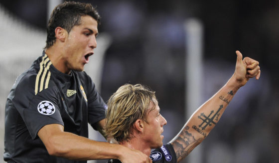 Real Madrid's Guti (C) celebrates his team's fith goal with teammate Cristiano Ronaldo (L) during their Champions League football game versus FC Zurich on September 15, 2009 in Zurich. Real Madrid won 5-2. AFP PHOTO / FABRICE COFFRINI (Photo credit should read FABRICE COFFRINI/AFP/Getty Images)