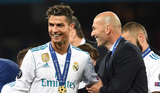 TOPSHOT - Real Madrid's French coach Zinedine Zidane (R) celebrates with Real Madrid's Portuguese forward Cristiano Ronaldo after winning the UEFA Champions League final football match between Liverpool and Real Madrid at the Olympic Stadium in Kiev, Ukraine, on May 26, 2018. (Photo by FRANCK FIFE / AFP) (Photo credit should read FRANCK FIFE/AFP/Getty Images)