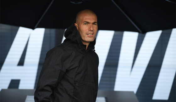 Former French football player and former Real Madrid coach Zinedine Zidane looks on as he shelters under an umbrella in Saint Denis, suburban Paris on June 11, 2018 during an event marking the 20th anniversary of France's 1998 World Cup victory. (Photo by Eric FEFERBERG / AFP) (Photo credit should read ERIC FEFERBERG/AFP/Getty Images)