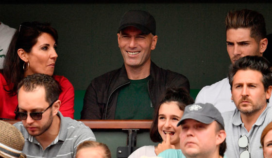 TOPSHOT - Former French football player and former Real Madrid's coach Zinedine Zidane, flanked by his wife Veronique (L) and their son Real Madrid's French goalkeeper Luca (R), looks on during the men's singles final match between Spain's Rafael Nadal and Austria's Dominic Thiem on day fifteen of The Roland Garros 2018 French Open tennis tournament in Paris on June 10, 2018. (Photo by CHRISTOPHE SIMON / AFP) (Photo credit should read CHRISTOPHE SIMON/AFP/Getty Images)