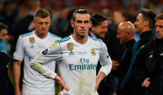 Real Madrid's Welsh forward Gareth Bale waits to collect his winner's medal on the pitch as Real Madrid players celebrate winning the UEFA Champions League final football match between Liverpool and Real Madrid at the Olympic Stadium in Kiev, Ukraine on May 26, 2018. - Real Madrid defeated Liverpool 3-1. (Photo by Paul ELLIS / AFP) (Photo credit should read PAUL ELLIS/AFP/Getty Images)