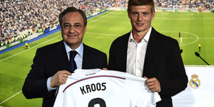 New Real Madrid's German midifielder Toni Kroos (R) poses with his new team's jersey past Real Madrid's President Florentino Perez during his presentation at the Santiago Bernabeu stadium in Madrid July 17, 2014. World Cup winner Toni Kroos became today Real Madrid's first high profile signing for the new season, moving from Bayern Munich on a six-year deal just days after winning the World Cup with Germany. AFP PHOTO/ JAVIER SORIANO (Photo credit should read JAVIER SORIANO/AFP/Getty Images)