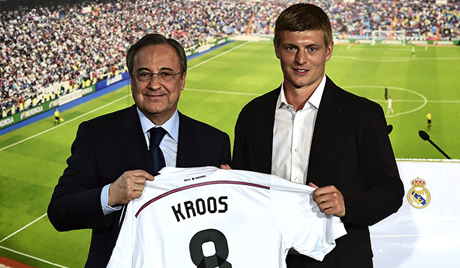 New Real Madrid's German midifielder Toni Kroos (R) poses with his new team's jersey past Real Madrid's President Florentino Perez during his presentation at the Santiago Bernabeu stadium in Madrid July 17, 2014. World Cup winner Toni Kroos became today Real Madrid's first high profile signing for the new season, moving from Bayern Munich on a six-year deal just days after winning the World Cup with Germany. AFP PHOTO/ JAVIER SORIANO (Photo credit should read JAVIER SORIANO/AFP/Getty Images)