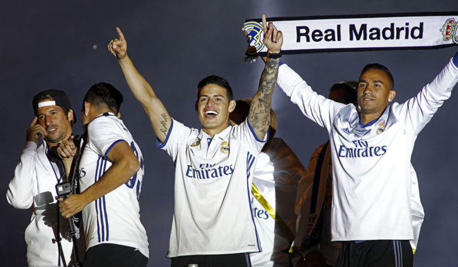Real Madrid's Colombian midfielder James Rodriguez (C) celebrates with teammates the team's win on Plaza Cibeles in Madrid on May 21, 2017 after the Sparish league football match Malaga CF vs Real Madrid CF held at La Rosaleda stadium in Malaga on May 21, 2017.