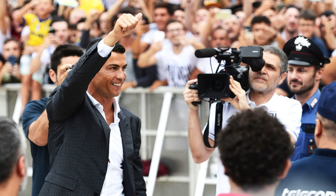 Portuguese footballer Cristiano Ronaldo waves to supporters as he arrives on July 16, 2018 at the Juventus medical centre at the Alliance stadium in Turin. - A Turin hit by Cristiano Ronaldo fever awaits the striker as Juventus prepare to unveil the surprise signing, that after the end of the World Cup, puts all eyes on the Italian champions and Serie A. (Photo by Miguel MEDINA / AFP) (Photo credit should read MIGUEL MEDINA/AFP/Getty Images)