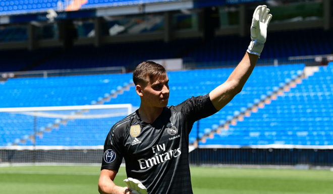 Real Madrid's new Ukrainian goalkeeper Andriy Lunin waves as he arrives to pose on the pitch during his official presentation at the Santiago Bernabeu Stadium in Madrid on July 23, 2018. (Photo by JAVIER SORIANO / AFP) (Photo credit should read JAVIER SORIANO/AFP/Getty Images)
