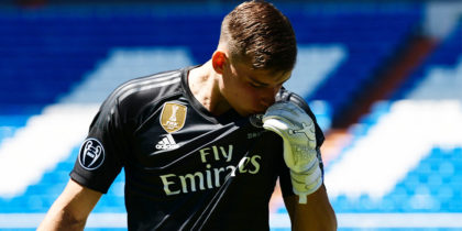 Real Madrid's new Ukrainian goalkeeper Andriy Lunin kisses his new jersey as he poses on the pitch during his official presentation at the Santiago Bernabeu Stadium in Madrid on July 23, 2018. (Photo by JAVIER SORIANO / AFP) (Photo credit should read JAVIER SORIANO/AFP/Getty Images)