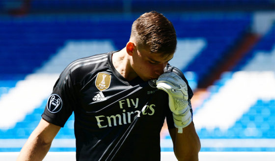 Real Madrid's new Ukrainian goalkeeper Andriy Lunin kisses his new jersey as he poses on the pitch during his official presentation at the Santiago Bernabeu Stadium in Madrid on July 23, 2018. (Photo by JAVIER SORIANO / AFP) (Photo credit should read JAVIER SORIANO/AFP/Getty Images)