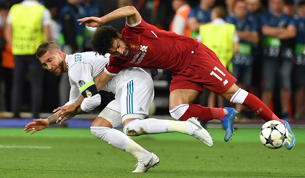 TOPSHOT - Liverpool's Egyptian forward Mohamed Salah (R) falls with Real Madrid's Spanish defender Sergio Ramos leading to Salah being injured during the UEFA Champions League final football match between Liverpool and Real Madrid at the Olympic Stadium in Kiev, Ukraine, on May 26, 2018. (Photo by GENYA SAVILOV / AFP) (Photo credit should read GENYA SAVILOV/AFP/Getty Images)