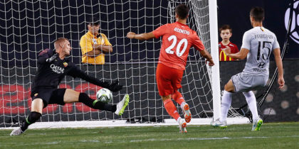 EAST RUTHERFORD, NJ - AUGUST 7: Marco Asensio #20 of Real Madrid scores on Robin Olsen #1 of Roma during their match at MetLife Stadium on August 7, 2018 in East Rutherford, New Jersey. (Photo by Jeff Zelevansky/Getty Images)