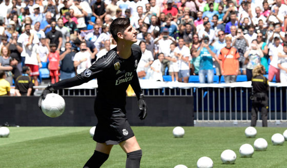 Belgian goalkeeper Thibaut Courtois throws balls to spectators during his presentation as new player of Real Madrid football team, at the Santiago Bernabeu stadium in Madrid on August 9, 2018. - Belgian international goalkeeper Thibaut Courtois will play the next six seasons at Real Madrid after confirming his transfer from Chelsea, while the white team has given the Croatian player Mateo Kovacic for a season to the English club. (Photo by JAVIER SORIANO / AFP) (Photo credit should read JAVIER SORIANO/AFP/Getty Images)