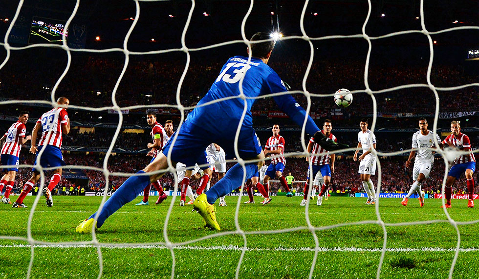 LISBON, PORTUGAL - MAY 24: Thibaut Courtois of Club Atletico de Madrid fails to stop Sergio Ramos of Real Madrid scoring their first goal during the UEFA Champions League Final between Real Madrid and Atletico de Madrid at Estadio da Luz on May 24, 2014 in Lisbon, Portugal. (Photo by Shaun Botterill/Getty Images)