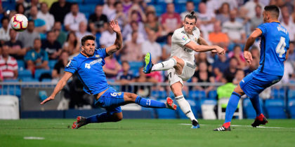 Real Madrid's Welsh forward Gareth Bale (C) kicks the ball past Getafe's Uruguayan defender Leandro Cabrera (L) and Getafe's Spanish defender Bruno Gonzalez (R) during the Spanish League football match between Real Madrid and Getafe at the Santiago Bernabeu stadium in Madrid on August 19, 2018. (Photo by JAVIER SORIANO / AFP) (Photo credit should read JAVIER SORIANO/AFP/Getty Images)