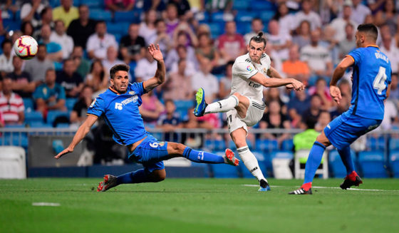 Real Madrid's Welsh forward Gareth Bale (C) kicks the ball past Getafe's Uruguayan defender Leandro Cabrera (L) and Getafe's Spanish defender Bruno Gonzalez (R) during the Spanish League football match between Real Madrid and Getafe at the Santiago Bernabeu stadium in Madrid on August 19, 2018. (Photo by JAVIER SORIANO / AFP) (Photo credit should read JAVIER SORIANO/AFP/Getty Images)