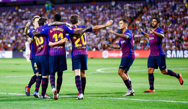 Barcelona's French forward Ousmane Dembele (3L) celebrates a goal with teammates during the Spanish league football match between Real Valladolid and FC Barcelona at the Jose Zorrilla Stadium in Valladolid on August 25, 2018. (Photo by Benjamin CREMEL / AFP) (Photo credit should read BENJAMIN CREMEL/AFP/Getty Images)