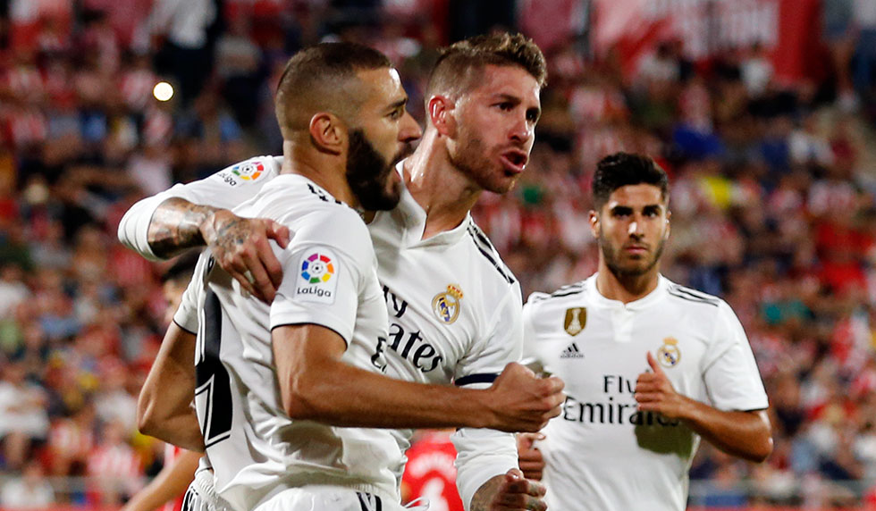 Real Madrid's French forward Karim Benzema (L) celebrates scoring his team's second goal with Real Madrid's Spanish defender Sergio Ramos during the Spanish league football match between Girona FC and Real Madrid CF at the Montilivi stadium in Girona on August 26, 2018. (Photo by Pau BARRENA CAPILLA / AFP) (Photo credit should read PAU BARRENA CAPILLA/AFP/Getty Images)