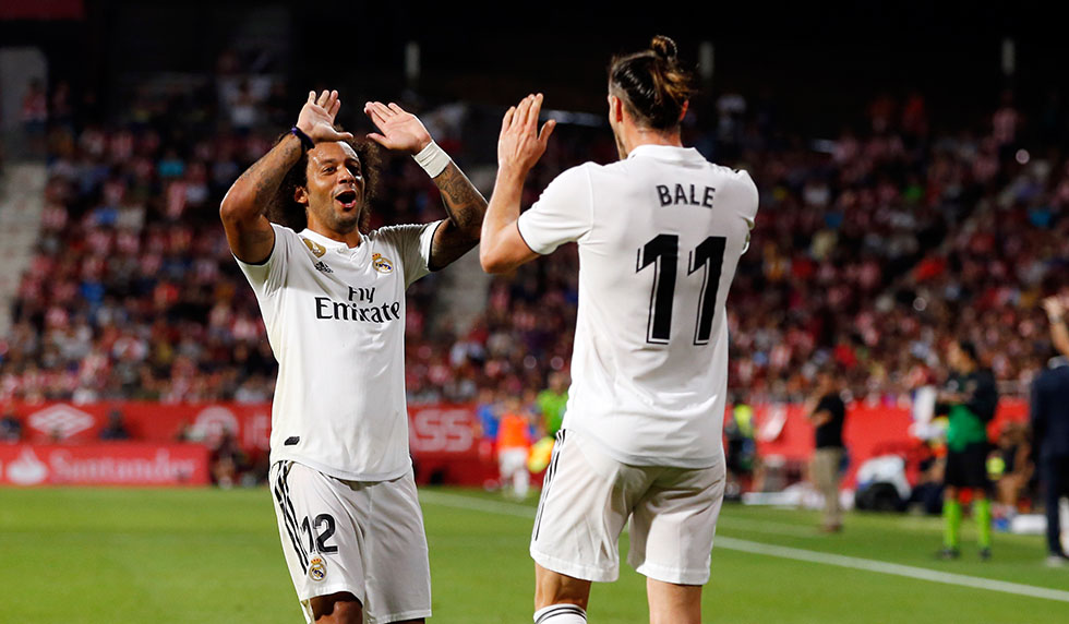 Real Madrid's Welsh forward Gareth Bale celebrates scoring his team's third goal with Real Madrid's Brazilian defender Marcelo during the Spanish league football match between Girona FC and Real Madrid CF at the Montilivi stadium in Girona on August 26, 2018. (Photo by Pau BARRENA CAPILLA / AFP) (Photo credit should read PAU BARRENA CAPILLA/AFP/Getty Images)