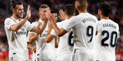 Real Madrid players celebrate their fourth goal scored by Real Madrid's French forward Karim Benzema during the Spanish league football match between Girona FC and Real Madrid CF at the Montilivi stadium in Girona on August 26, 2018. (Photo by Pau BARRENA CAPILLA / AFP) (Photo credit should read PAU BARRENA CAPILLA/AFP/Getty Images)