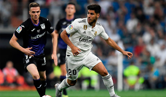 Real Madrid's Spanish midfielder Marco Asensio challenges Leganes' Spanish midfielder Javier Eraso (L) during the Spanish league football match between Real Madrid CF and Club Deportivo Leganes SAD at the Santiago Bernabeu stadium in Madrid on September 1, 2018. (Photo by GABRIEL BOUYS / AFP) (Photo credit should read GABRIEL BOUYS/AFP/Getty Images)