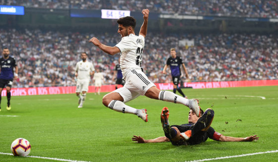 MADRID, SPAIN - SEPTEMBER 01: Marco Asensio of Real Madrid is fouled in the penalty area by Unai Bustinza of CD Leganes during the La Liga match between Real Madrid CF and CD Leganes at Estadio Santiago Bernabeu on September 1, 2018 in Madrid, Spain. Sergio Ramos converted the penalty for their 4th goal. (Photo by Denis Doyle/Getty Images)