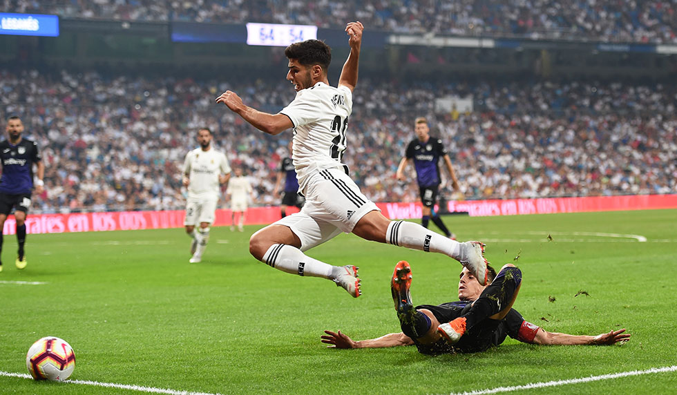 MADRID, SPAIN - SEPTEMBER 01: Marco Asensio of Real Madrid is fouled in the penalty area by Unai Bustinza of CD Leganes during the La Liga match between Real Madrid CF and CD Leganes at Estadio Santiago Bernabeu on September 1, 2018 in Madrid, Spain. Sergio Ramos converted the penalty for their 4th goal. (Photo by Denis Doyle/Getty Images)