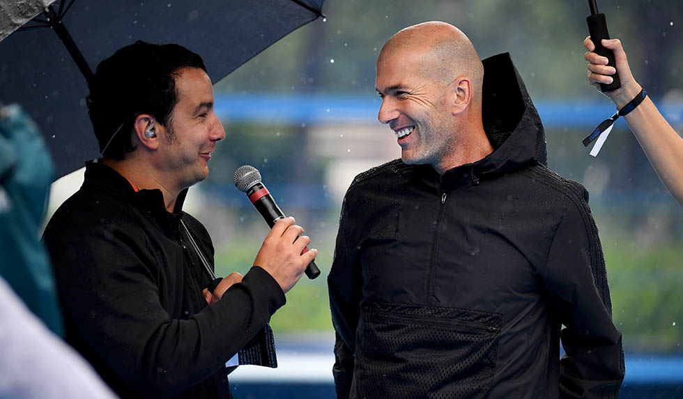 Former French football player and former Real Madrid coach Zinedine Zidane (C) speaks with French TV Sports commentator Thomas Thouroude (L) in Saint Denis, suburban Paris on June 11, 2018 during an event marking the 20th anniversary of France's 1998 World Cup victory. (Photo by Eric FEFERBERG / AFP) (Photo credit should read ERIC FEFERBERG/AFP/Getty Images)