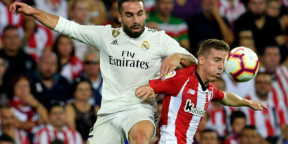 Real Madrid's Spanish defender Dani Carvajal (L) vies wuth Athletic Bilbao's Spanish forward Iker Muniain during the Spanish league football match between Athletic Club Bilbao and Real Madrid CF at the San Mames stadium in Bilbao on September 15, 2018. (Photo by LLUIS GENE / AFP) (Photo credit should read LLUIS GENE/AFP/Getty Images)