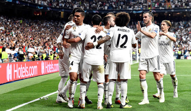 Real Madrid players celebrate the opening goal during the UEFA Champions League group G football match between Real Madrid CF and AS Roma at the Santiago Bernabeu stadium in Madrid on September 19, 2018. (Photo by OSCAR DEL POZO / AFP) (Photo credit should read OSCAR DEL POZO/AFP/Getty Images)