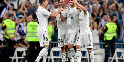 Real Madrid's Spanish midfielder Marco Asensio (C) celebrates with teammtes after scoring during the Spanish league football match between Real Madrid CF and RCD Espanyol at the Santiago Bernabeu stadium in Madrid on September 22, 2018. (Photo by JAVIER SORIANO / AFP) (Photo credit should read JAVIER SORIANO/AFP/Getty Images)