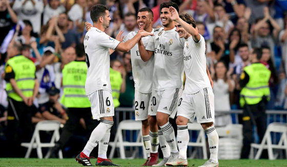 Real Madrid's Spanish midfielder Marco Asensio (C) celebrates with teammtes after scoring during the Spanish league football match between Real Madrid CF and RCD Espanyol at the Santiago Bernabeu stadium in Madrid on September 22, 2018. (Photo by JAVIER SORIANO / AFP) (Photo credit should read JAVIER SORIANO/AFP/Getty Images)