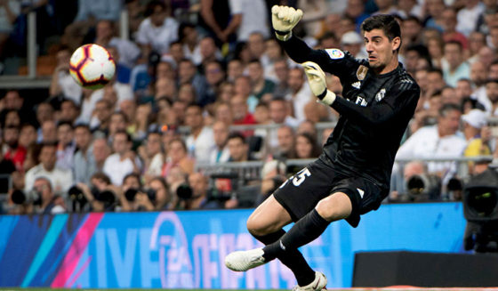 Real Madrid's Belgian goalkeeper Thibaut Courtois dives for the ball during the Spanish league football match between Real Madrid CF and Club Atletico de Madrid at the Santiago Bernabeu stadium in Madrid on September 29, 2018. (Photo by CURTO DE LA TORRE / AFP) (Photo credit should read CURTO DE LA TORRE/AFP/Getty Images)