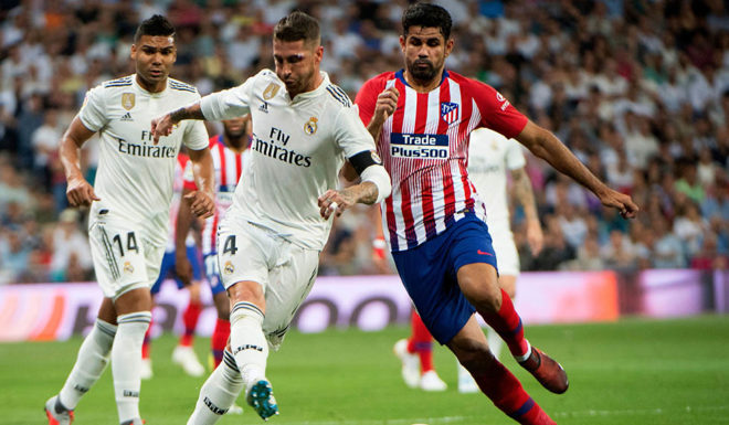 Real Madrid's Spanish defender Sergio Ramos (L) vies with Atletico Madrid's Spanish forward Diego Costa during the Spanish league football match between Real Madrid CF and Club Atletico de Madrid at the Santiago Bernabeu stadium in Madrid on September 29, 2018. (Photo by CURTO DE LA TORRE / AFP) (Photo credit should read CURTO DE LA TORRE/AFP/Getty Images)