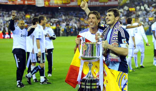 Real Madrid's goalkeeper and captain Iker Casillas (R) and Real Madrid's defender Sergio Ramos celebrate with the trophy after winning the Spanish Cup final match Real Madrid against Barcelona at the Mestalla stadium in Valencia on April 20, 2011. Real Madrid won 1-0. AFP PHOTO / PIERRE-PHILIPPE MARCOU (Photo credit should read PIERRE-PHILIPPE MARCOU/AFP/Getty Images)