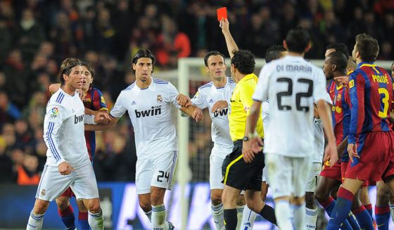 CORRECTION IDENTIFICATION IN CAPTION The referee shows a red card to Real Madrid's defender Sergio Ramos (L) under the look of teammate Real Madrid's German midfielder Sami Khedira (2ndL) during the Spanish league "clasico" football match FC Barcelona vs Real Madrid on November 29, 2010 at Camp Nou stadium in Barcelona. Barcelona won 5-0. AFP PHOTO/ LLUIS GENE (Photo credit should read LLUIS GENE/AFP/Getty Images)