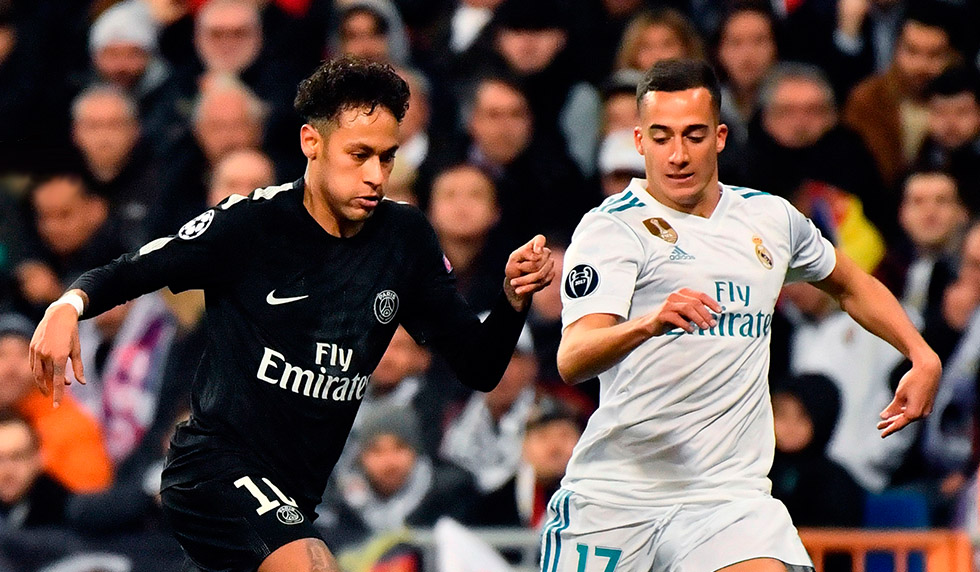 TOPSHOT - Paris Saint-Germain's Brazilian forward Neymar (C) vies with Real Madrid's German midfielder Toni Kroos (L) and Real Madrid's Spanish midfielder Lucas Vazquez during the UEFA Champions League round of sixteen first leg football match Real Madrid CF against Paris Saint-Germain (PSG) at the Santiago Bernabeu stadium in Madrid on February 14, 2018. / AFP PHOTO / CHRISTOPHE SIMON (Photo credit should read CHRISTOPHE SIMON/AFP/Getty Images)