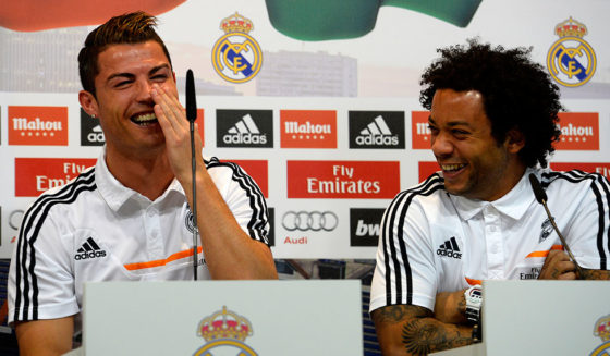 Real Madrid's Portuguese forward Cristiano Ronaldo (L) and Brazilian defender Marcelo laugh as they give a press conference with their teammates to give their thoughts on 2014 World Cup draw, at the Valdebebas training ground in Madrid on December 8, 2013. AFP PHOTO/ GERARD JULIEN (Photo credit should read GERARD JULIEN/AFP/Getty Images)