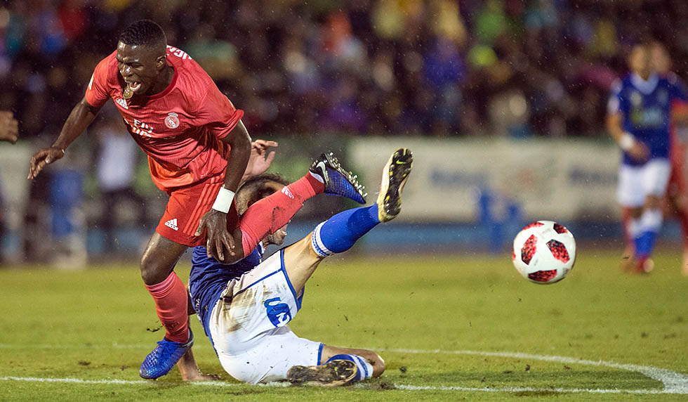 Real Madrid's Brazilian forward Vinicius Junior (L) vies with UD Melilla's Spanish defender Ricardo Segura Richi during the Spanish King's Cup football match between UD Melilla and Real Madrid CF at the Alvarez Claro municipal stadium in the autonomous city of Melilla on October 31, 2018. (Photo by JORGE GUERRERO / AFP) (Photo credit should read JORGE GUERRERO/AFP/Getty Images)