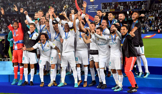 Real Madrid players celebrate with the FIFA Club World Cup trophy following their victory in the final football match against Gremio at Zayed Sports City Stadium in the Emirati capital Abu Dhabi on December 16, 2017. Real Madrid defeated Gremio 1-0 to lift the FIFA Club World Cup for the third time in their history. / AFP PHOTO / Giuseppe CACACE (Photo credit should read GIUSEPPE CACACE/AFP/Getty Images)