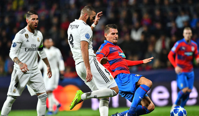 Real Madrid's French forward Karim Benzema and Viktoria Plzen's Czech defender Lukas Hejda vie for the ball during the UEFA Champions League group G football match Viktoria Plzen v Real Madrid in Plzen, Czech Republic on November 7, 2018. (Photo by JOE KLAMAR / AFP) (Photo credit should read JOE KLAMAR/AFP/Getty Images)