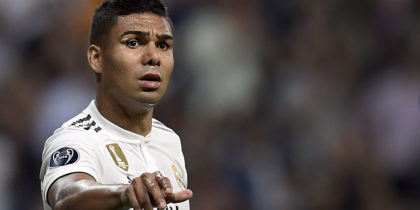 Real Madrid's Brazilian midfielder Casemiro throws a bottle of water to a teammates during the UEFA Champions League group G football match between Real Madrid CF and AS Roma at the Santiago Bernabeu stadium in Madrid on September 19, 2018. (Photo by OSCAR DEL POZO / AFP) (Photo credit should read OSCAR DEL POZO/AFP/Getty Images)