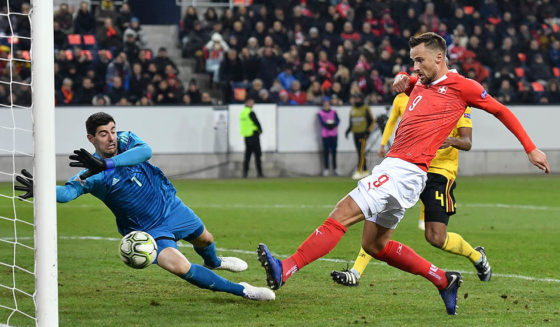 Switzerland's forward Haris Seferovic (R) scores his team's second goal past Belgium's goalkeeper Thibaut Courtois (L) during the UEFA Nations League, League A, Group 2, football match between Switzerland and Belgium at the Swissporarena Stadium in Lucerne on November 18, 2018. (Photo by Fabrice COFFRINI / AFP) (Photo credit should read FABRICE COFFRINI/AFP/Getty Images)