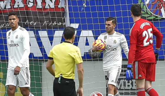(fromL) Real Madrid's French defender Raphael Varane, Real Madrid's Spanish midfielder Daniel Ceballos and Real Madrid's Belgian goalkeeper Thibaut Courtois react after Eibar's Spanish forward Sergi Enrich scored during the Spanish league football match between SD Eibar and Real Madrid CF at the Ipurua stadium in Eibar on November 24, 2018. (Photo by ANDER GILLENEA / AFP) (Photo credit should read ANDER GILLENEA/AFP/Getty Images)