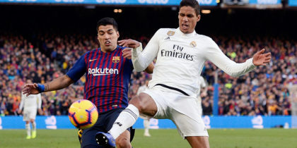 Barcelona's Uruguayan forward Luis Suarez (L) vies with Real Madrid's French defender Raphael Varane during the Spanish league football match between FC Barcelona and Real Madrid CF at the Camp Nou stadium in Barcelona on October 28, 2018. (Photo by Josep LAGO / AFP) (Photo credit should read JOSEP LAGO/AFP/Getty Images)