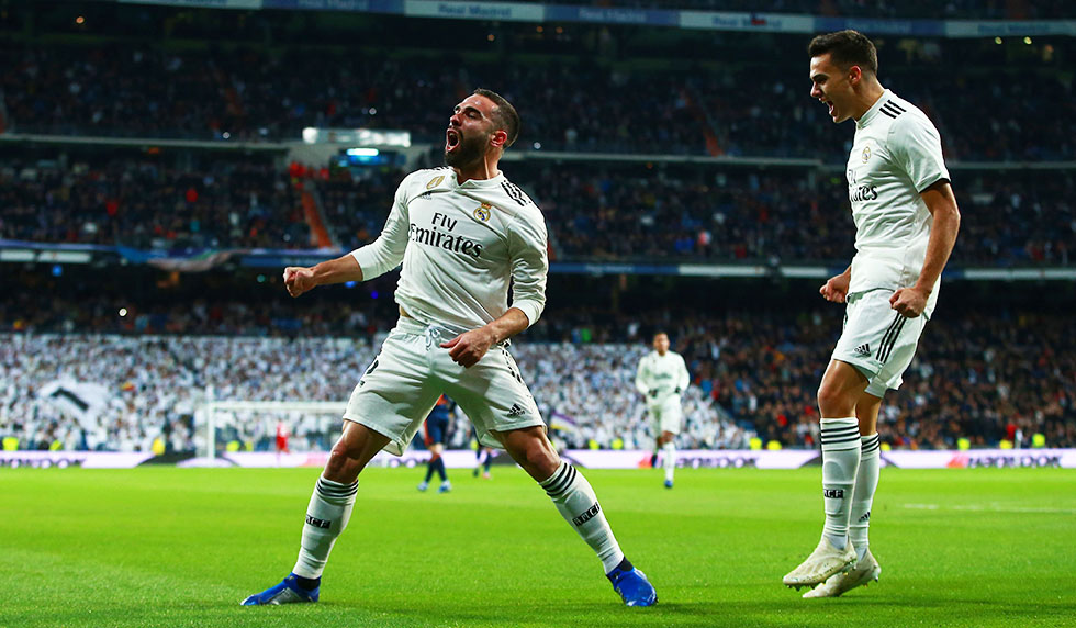 MADRID, SPAIN - DECEMBER 01: Daniel Carvajal of Real Madrid (L) celebrates with Sergio Reguilon as Daniel Wass of Valencia scores an own goal for their first goal during the La Liga match between Real Madrid CF and Valencia CF at Estadio Santiago Bernabeu on December 01, 2018 in Madrid, Spain. (Photo by Gonzalo Arroyo Moreno/Getty Images)