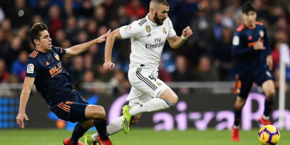 Real Madrid's French forward Karim Benzema challenges Valencia's Brazilian defender Gabriel Paulista (L) during the Spanish league football match between Real Madrid and Valencia at the Santiago Bernabeu stadium in Madrid on December 1, 2018. (Photo by OSCAR DEL POZO / AFP) (Photo credit should read OSCAR DEL POZO/AFP/Getty Images)
