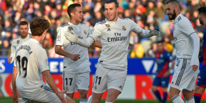 Real Madrid's Welsh forward Gareth Bale (C) celebrates after scoring his team's first goal during the Spanish league football match between SD Huesca and Real Madrid CF at the El Alcoraz stadium on December 9, 2018. (Photo by ANDER GILLENEA / AFP) (Photo credit should read ANDER GILLENEA/AFP/Getty Images)