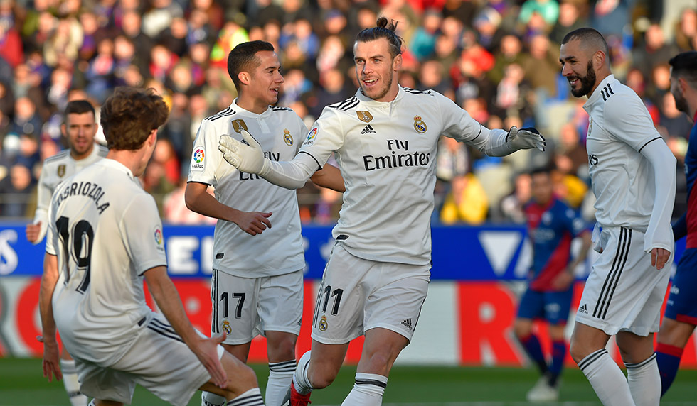 Real Madrid's Welsh forward Gareth Bale (C) celebrates after scoring his team's first goal during the Spanish league football match between SD Huesca and Real Madrid CF at the El Alcoraz stadium on December 9, 2018. (Photo by ANDER GILLENEA / AFP) (Photo credit should read ANDER GILLENEA/AFP/Getty Images)