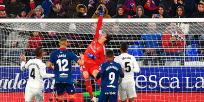Real Madrid's Belgian goalkeeper Thibaut Courtois hits the ball with his fist during the Spanish league football match between SD Huesca and Real Madrid CF at the El Alcoraz stadium in Huesca, on December 9, 2018. (Photo by ANDER GILLENEA / AFP) (Photo credit should read ANDER GILLENEA/AFP/Getty Images)